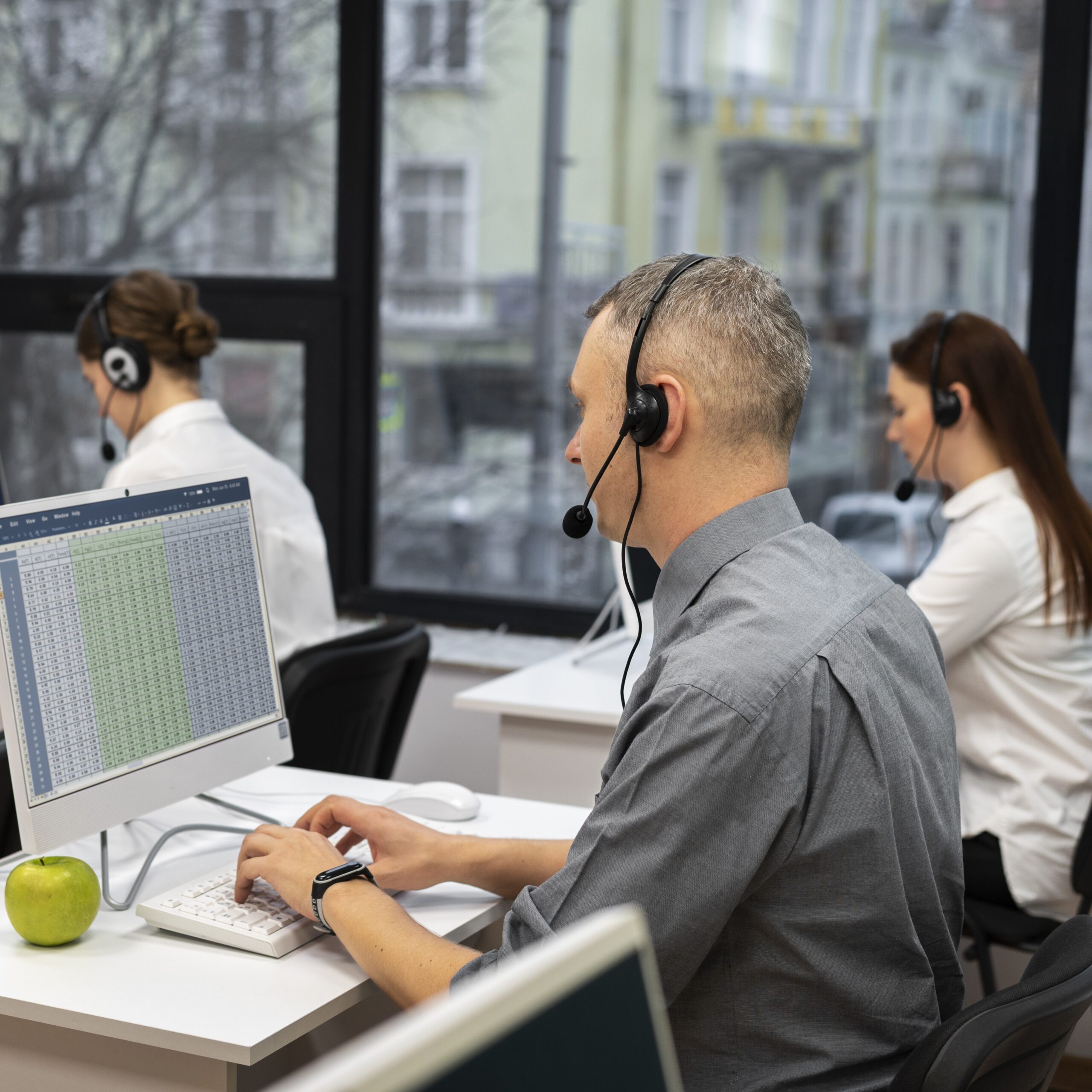 colleagues-working-together-call-center-with-headphones